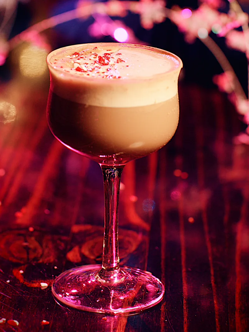 A frothy cocktail topped with crushed peppermint candy