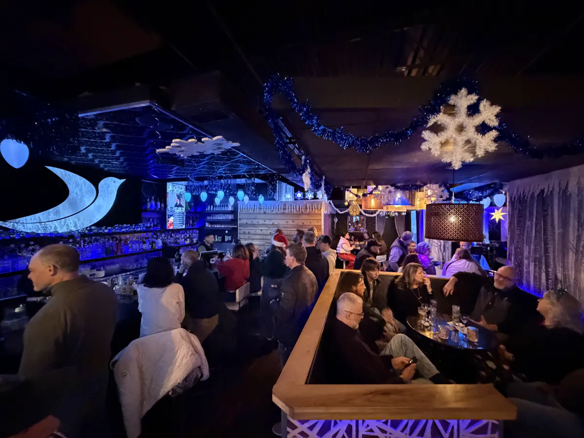 Guests gathered beneath blue lights and hanging snowflakes at Winter Wonderland in Des Moines